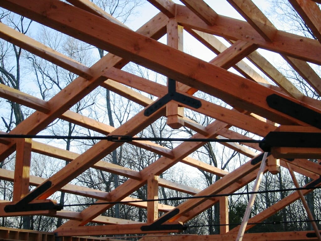 Heavy timber modified scissor truss with steel tie rod