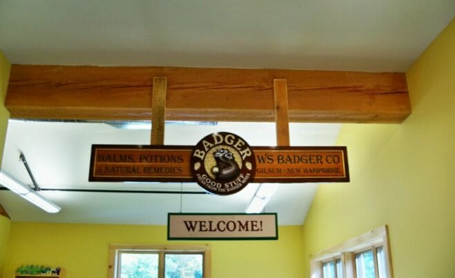 Badger Balm Welcome Sign Hanging from a Douglas Fir Beam