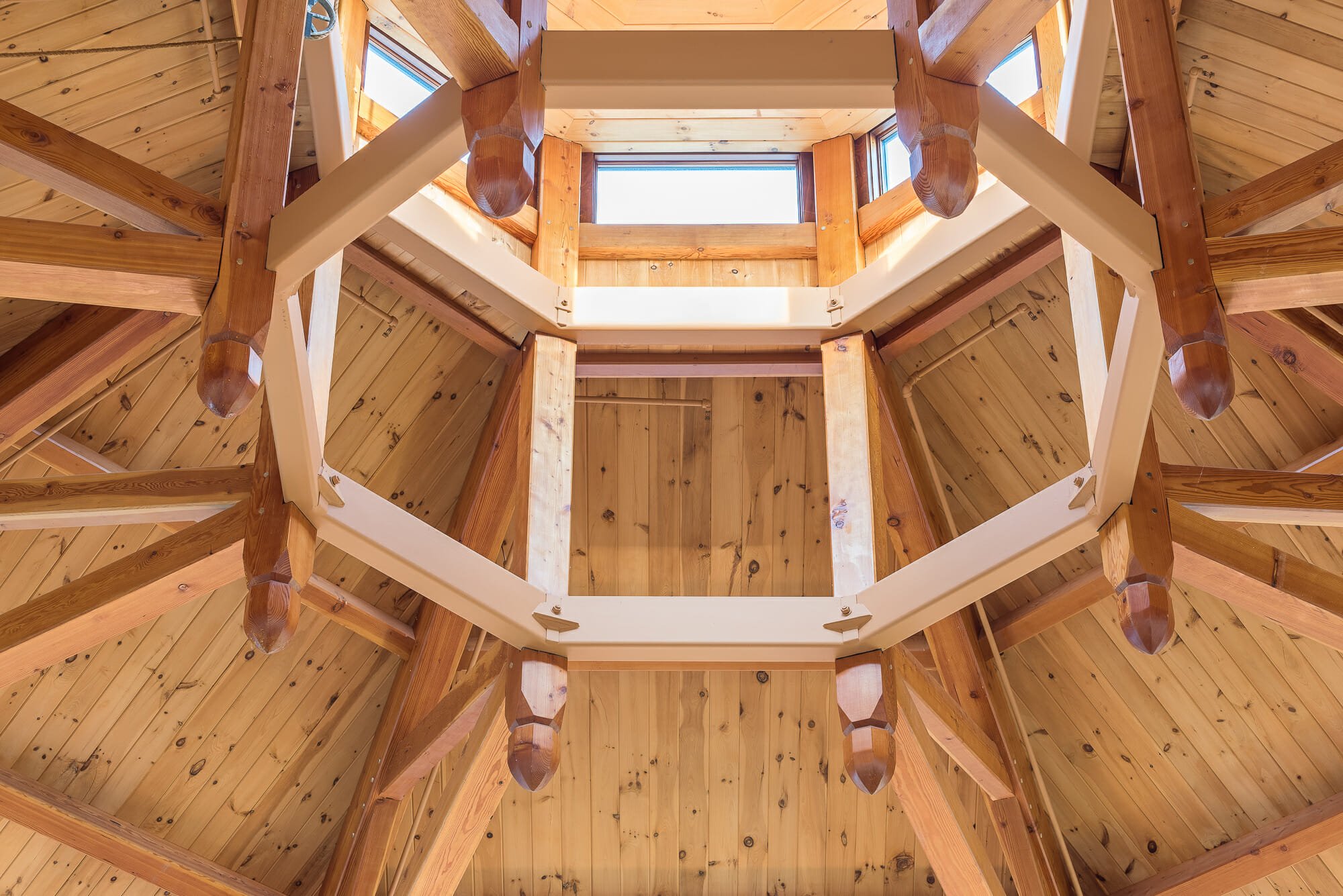 Close up of the steel compression ring and timbers in the Octagon Timber Frame in the Chapel for Holy Apostles Church