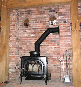 Brick Wall, Timber Beams, and a Black Fireplace