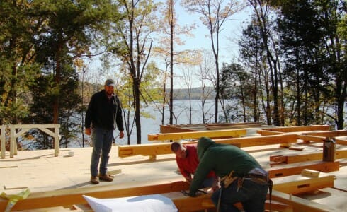 Crew Assembling Timber Home