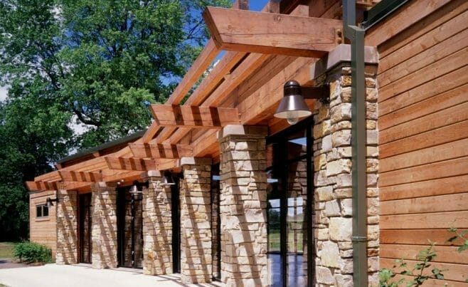 Timber Building at Citizen's Park With a Beautiful Overhang and Stone Columns