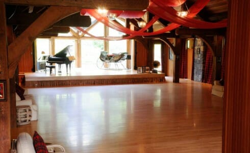 Ballroom with Stone Walls, Heavy Timber Trusses, and Red Decor