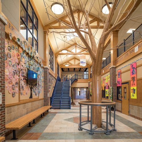 Interior of Westbrook Middle School with King post trusses in ME