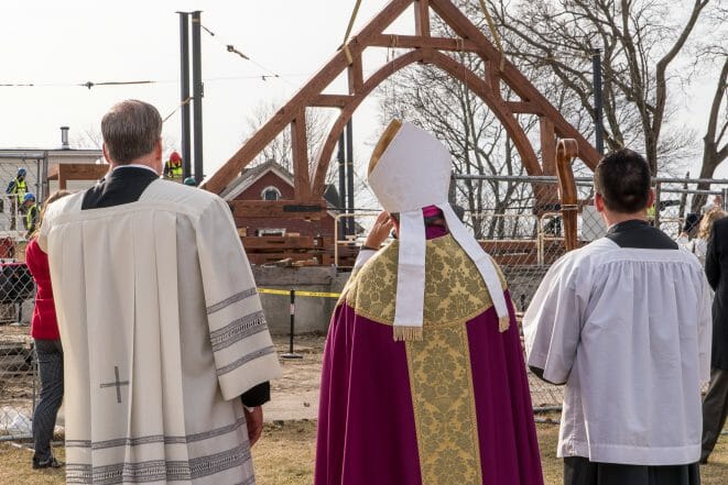 Raising the Trusses while the clergy looks on at the Church of St. Michael the Archangel