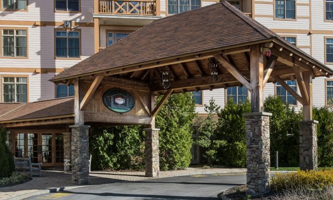 Timber Frame Lodge with Heavy Timber Porte Cochere Entryway at Founders Lodge in Vermont