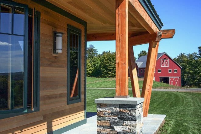 Exterior beams with stone post bases on the porch of the Night Pasture Farm in Chelsea, VT