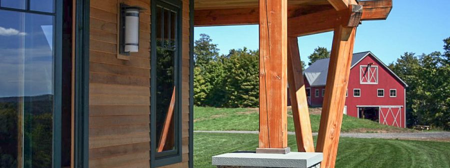 Exterior beams with stone post bases on the porch of the Night Pasture Farm in Chelsea, VT
