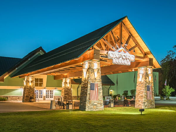 Heavy timber Porte Cochère with sunburst truss design and stone pillars at the Oxford Casino