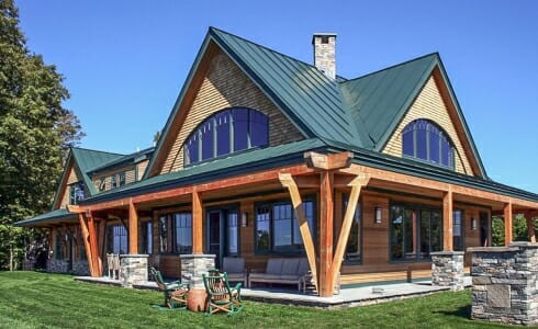 Exterior of the Night Pasture Farm with beams with stone post bases on the porch in Chelsea, VT