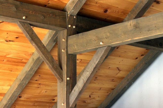 Timber Post with Brace and Rafter tie with traditional joinery in a timber frame home
