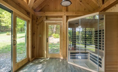 A Sauna in an workout room barn with heavy timber posts and beams