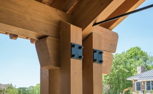 The Mahamudra Buddhist Retreat in Cragsmoor, NY has a heavy timber entryway and interior trusses fabricated from Glulam and Douglas Fir. The entryway features scrolls and black steel.