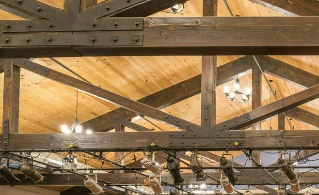 Timber Trusses with steel plates and mounted stage lights in a performance space in the Hopkinton Art Center