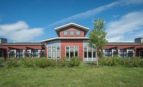 Exterior of Harmony Homes Living Facility with backyard Patio Timber Frame Pavilion and Wood Details