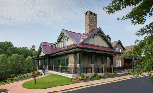 Douglas fir trusses in the Golf Club at South River featuring cathedral ceilings, a large open dining room, and a tall stone fireplace. The exterior of Golf Club at South River.