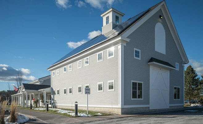 Exterior of the Hopkington Art Center with white washed timber porch and interior dark stained trusses