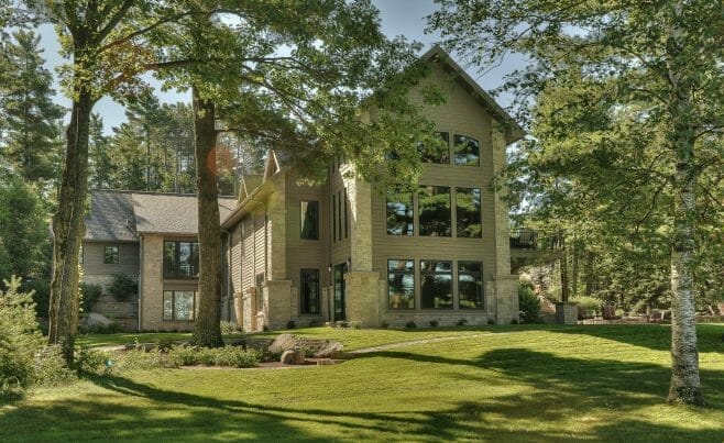 Exterior of the Minocqua Residence that features arched king trusses, cathedral ceilings and windows.