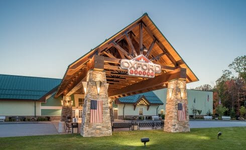 Heavy Timber Porte Cochere Entry Way at the Oxford Casino in Maine with King post trusses in White Pine with steel plates.