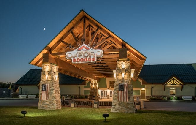 Heavy Timber Porte Cochere Entry Way at the Oxford Casino in Maine with King post trusses in White Pine with steel plates.