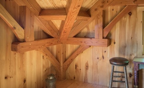 Complex joinery and connection joining post and beams and trusses in the Ox Hill Barn fabricated from Glulam and Douglas Fir