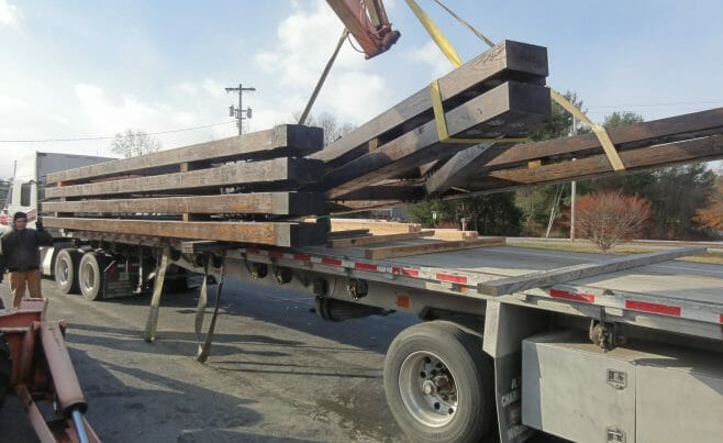 Timber Trusses being loaded onto a truck with a crane