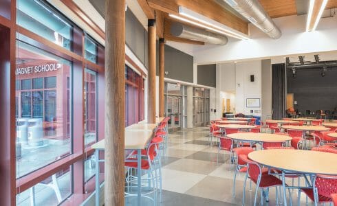 Glulam Posts and beams with black steel in the Magnet School dining cafeteria.