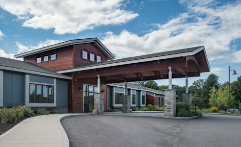 Porte Cochere Entryway with stone post bases at Harmony Homes Living Facility