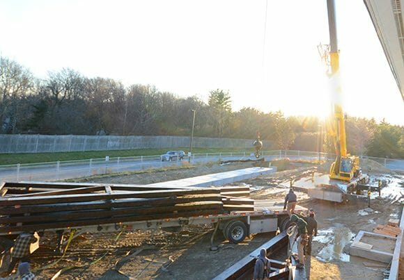 Loading the timber trusses onto the truck with a crane for the Hopkinton Art Center