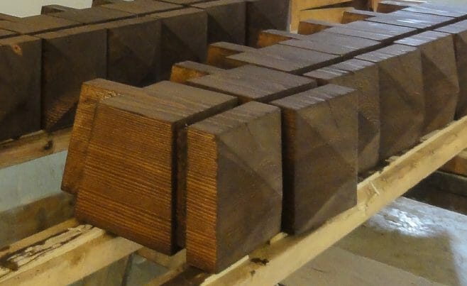 Square Finials being stained during the fabrication process