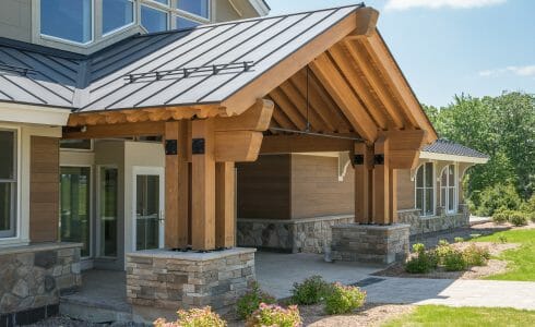 The Mahamudra Buddhist Retreat in Cragsmoor, NY has a heavy timber entryway and interior trusses fabricated from Glulam and Douglas Fir. The entryway features scrolls and black steel.