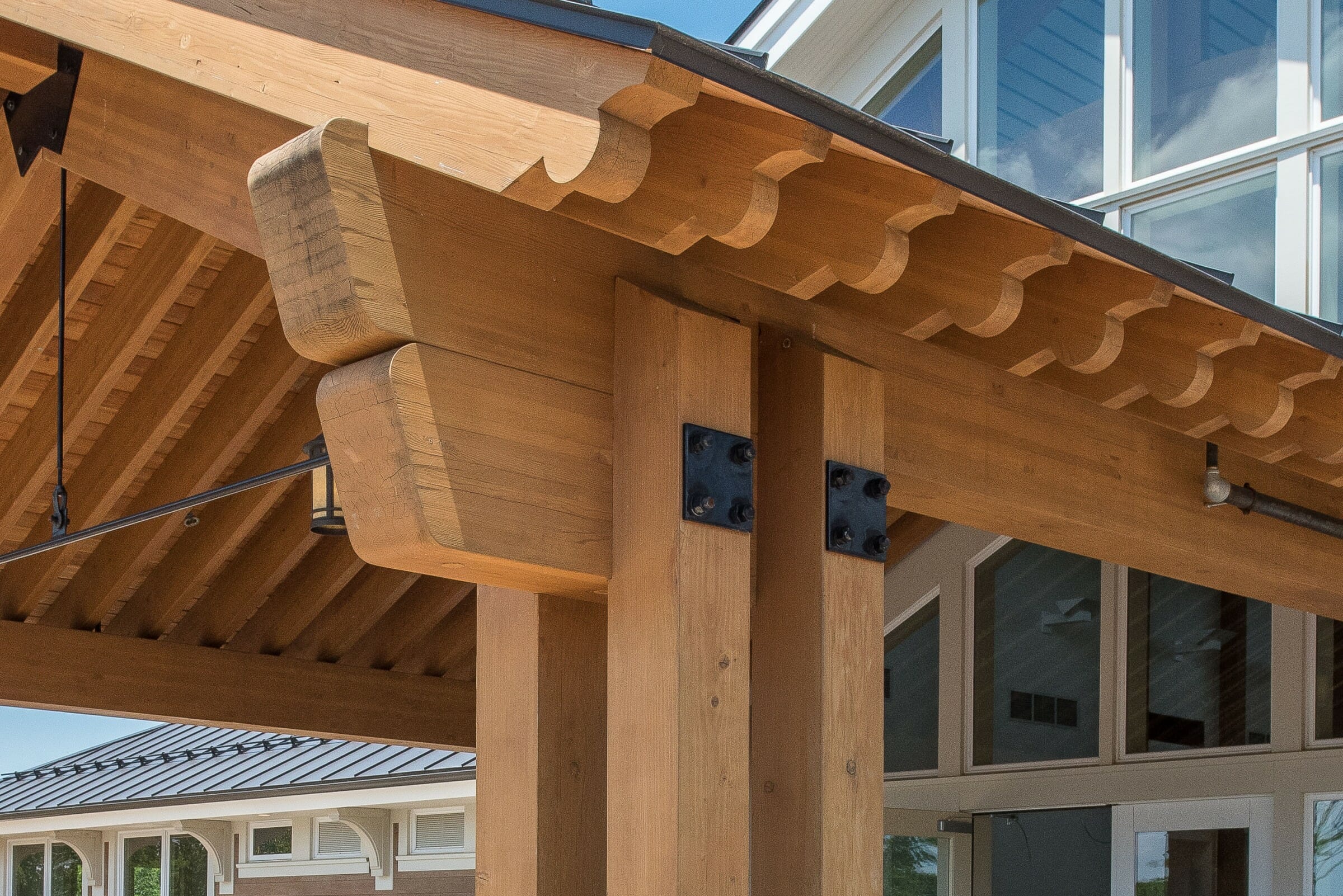 Timber Frame Scrolls on a Porte Cochere with steel plates and tie rods