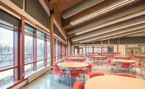 Glulam Posts and beams with black steel in the Magnet School dining cafeteria.