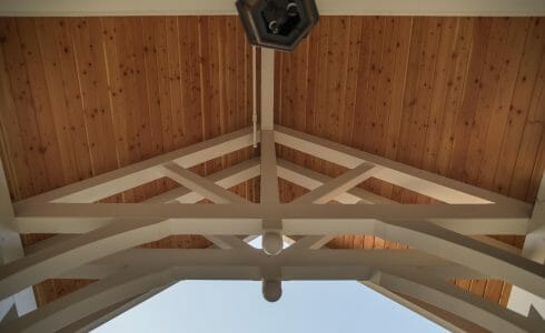 White Entry Canopy with king post trusses at Fuller Hall at the Vermont Academy school made with douglas fir