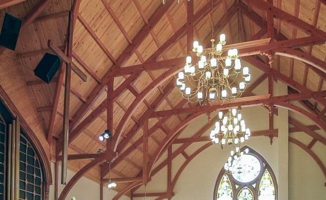 Arched Hammer Beams Against A White Plaster Wall