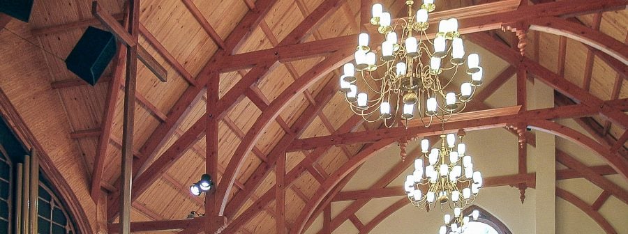 Arched Hammer Beams Against A White Plaster Wall