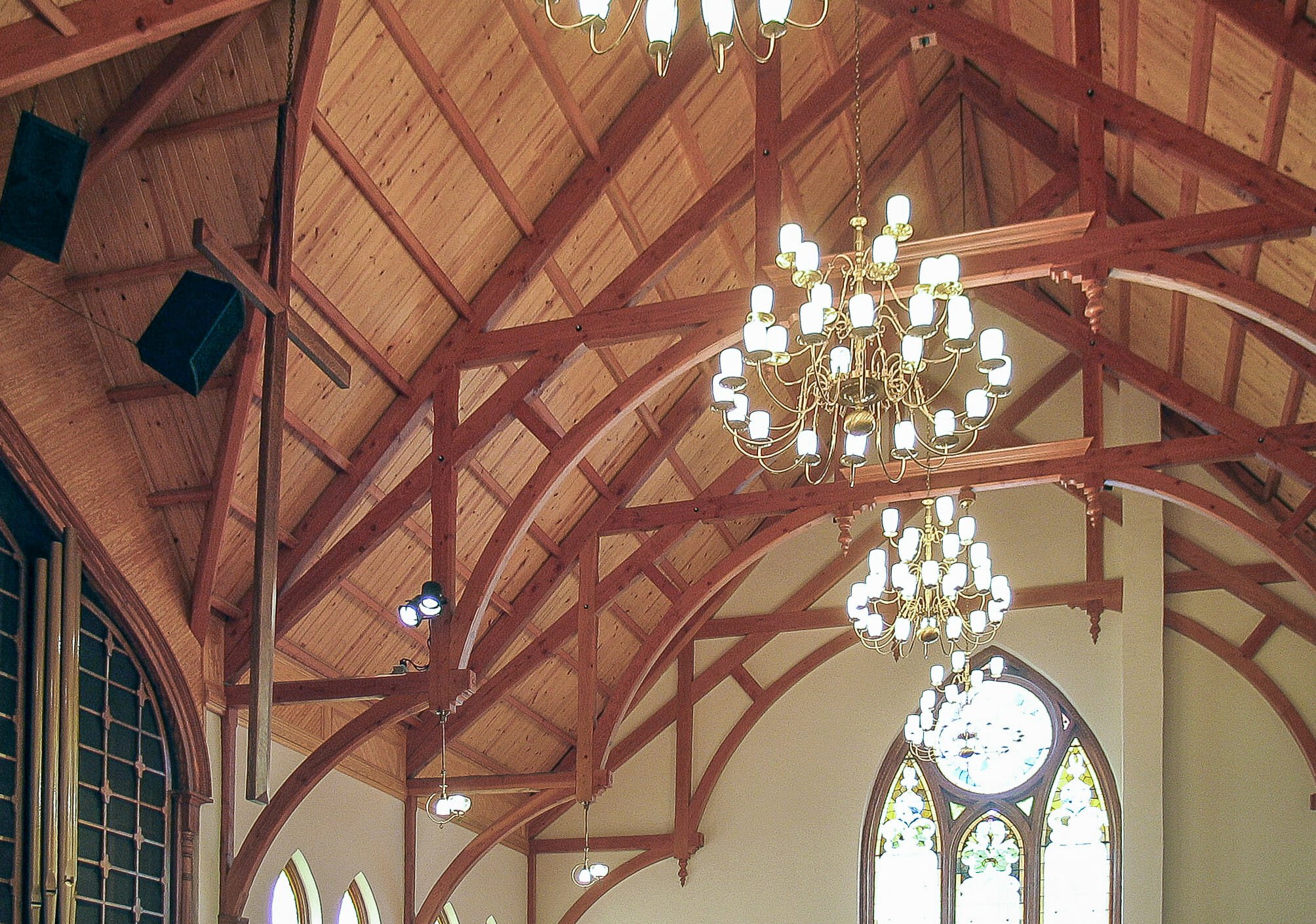 Arched Hammer Beams Against A White Plaster Wall