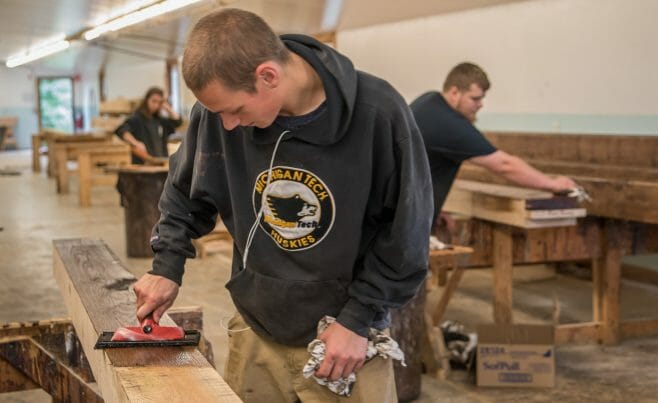 Applying stain on wood with a pad