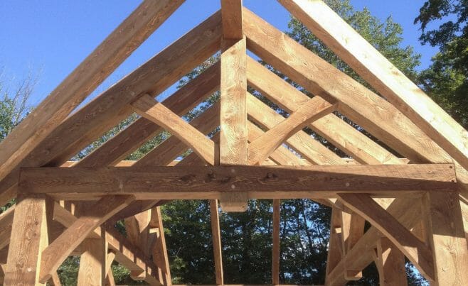 Pool House Timber Frame in CT. Pool patio with fireplace and rustic heavy timber pavilion.