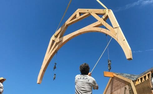 Positioning the reclaimed oak hammer beam truss in the Seven Gates Residence in Martha's Vineyard