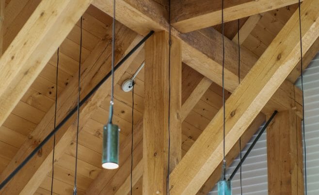 Hanging Lights in the Vermont Veterans Memorial Chapel. This church was made with Hemlock and Pine and features Girder Trusses.