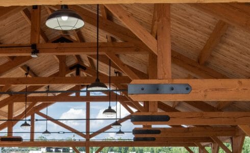 Timber Frame King Post Trusses with black steel plates in a pavilion at the Bechtel Summit home of the National Boy Scout Jamboree