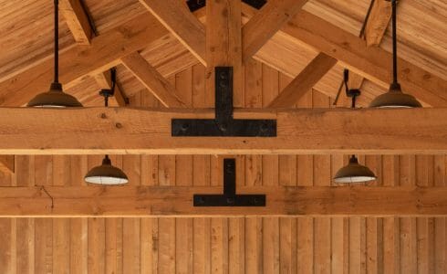 Timber Frame King Post Trusses with black steel plates in a pavilion at the Bechtel Summit home of the National Boy Scout Jamboree