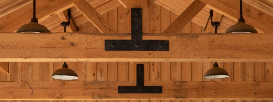 Timber Frame King Post Trusses with black steel plates in a pavilion at the Bechtel Summit home of the National Boy Scout Jamboree