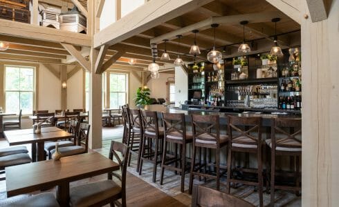 Interior of the Briar Barn Inn in Rowley, MA. The Monitor style barn features rough sawn Hemlock posts, beams, and trusses.