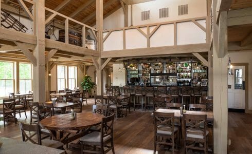 Interior of the Briar Barn Inn in Rowley, MA. The Monitor style barn features rough sawn Hemlock posts, beams, and trusses.