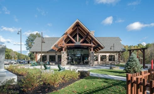 Exterior of the Adirondack Welcome Center in Queensbury, NY featuring Douglas fir Glulam Heavy Timber Trusses with steel plates.