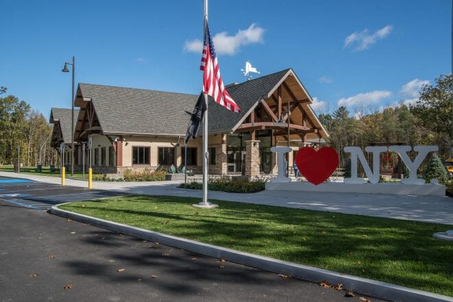 Exterior of the Adirondack Welcome Center in Queensbury, NY featuring Douglas fir Glulam Heavy Timber Trusses with steel plates.