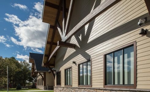 Exterior of the Adirondack Welcome Center in Queensbury, NY featuring Douglas fir Glulam Heavy Timber Trusses with steel plates.