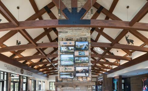 Interior of the Adirondack Welcome Center in Queensbury, NY featuring Douglas fir Glulam Heavy Timber Trusses with steel plates.